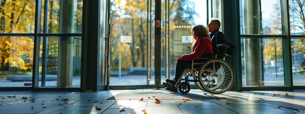 a person in a wheelchair being interviewed by a professional inspector at a public building entrance.