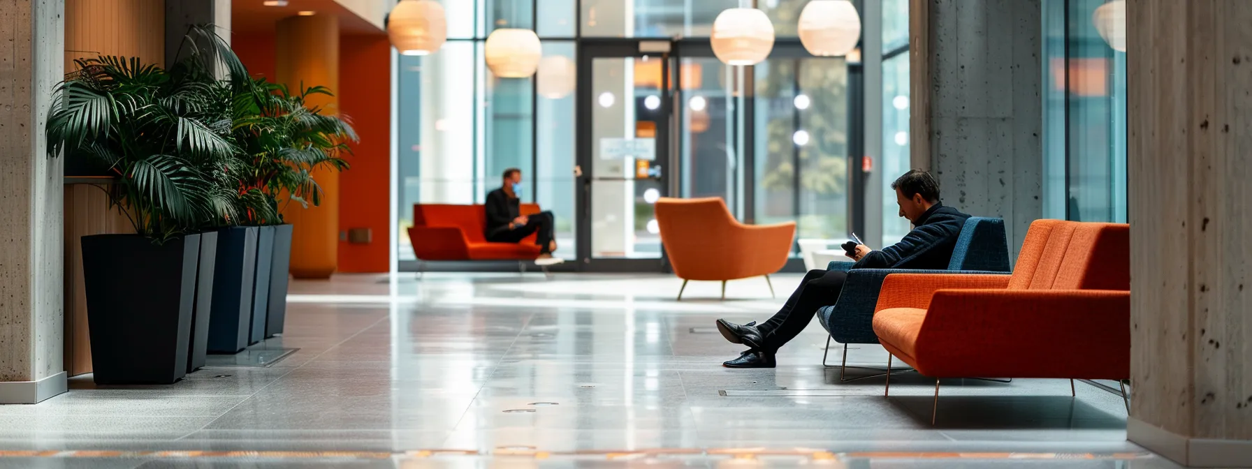 a person sitting comfortably in a spacious and accessible seating area in a commercial building.