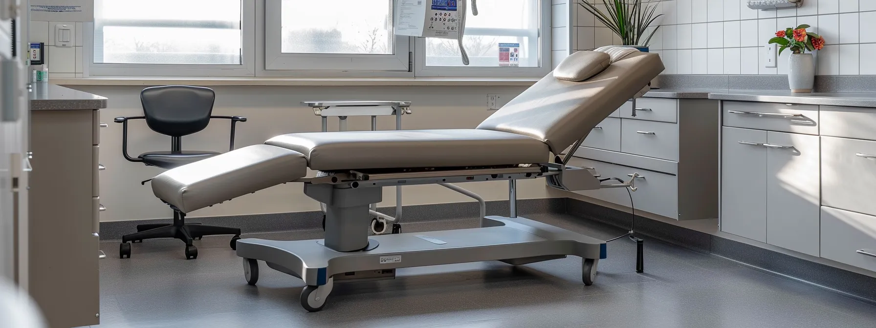 a wheelchair-accessible examination table in a medical facility with ample knee space underneath.